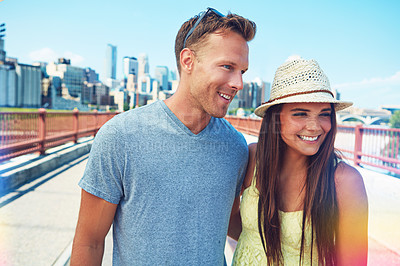 Buy stock photo Cropped shot of a young couple out on a date in the city