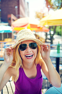 Buy stock photo Portrait of an attractive young woman sitting at an outdoor cafe