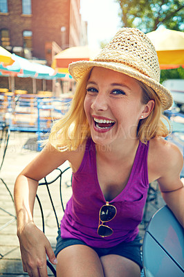 Buy stock photo Portrait of an attractive young woman sitting at an outdoor cafe