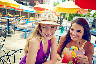 Buy stock photo Portrait of two attractive young women sitting at an outdoor cafe