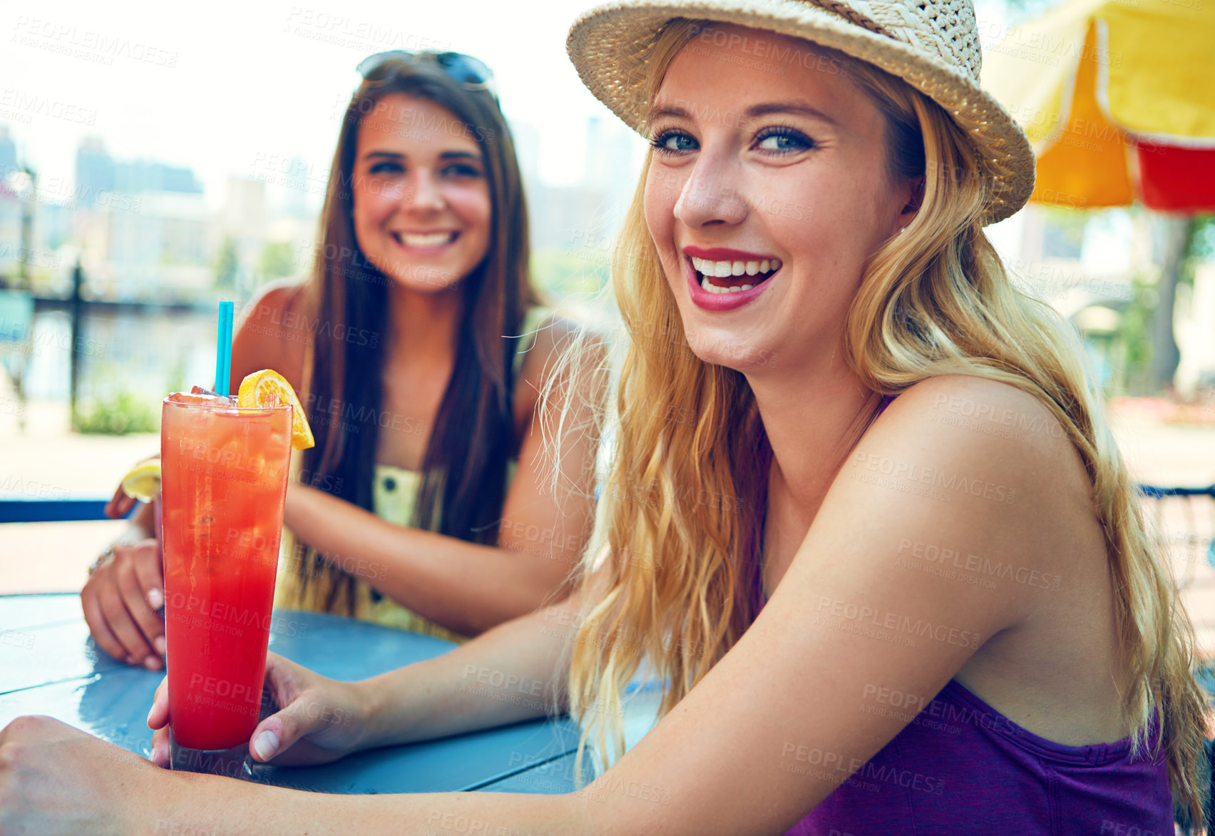 Buy stock photo Portrait of two attractive young women sitting at an outdoor cafe