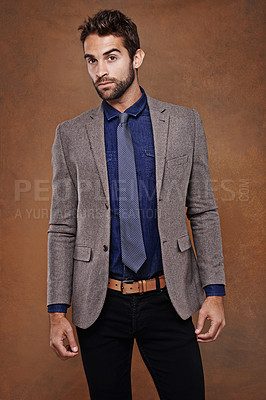 Buy stock photo Suit, style and portrait of man in studio with confidence for trendy, classy and stylish outfit. Cool, fashion and male model with pride for elegant, fancy or luxury clothes by brown background.