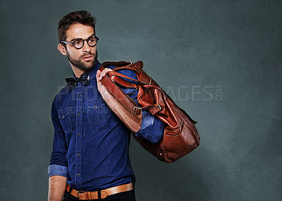 Buy stock photo Travel, bag and man with fashion thinking of vacation in studio, background and mockup for business. Formal, style and luxury leather luggage for airport, journey to Italy and model with glasses