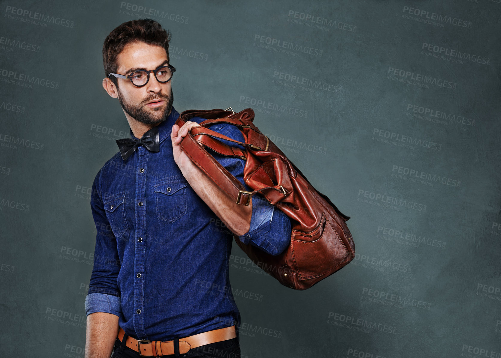 Buy stock photo Travel, bag and man with fashion thinking of vacation in studio, background and mockup for business. Formal, style and luxury leather luggage for airport, journey to Italy and model with glasses