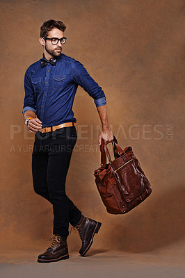 Buy stock photo Travel, bag and man with fashion walking in studio, background and mockup for business vacation. Formal, style and model with luxury luggage for airport, journey to Italy and Italian leather shoes