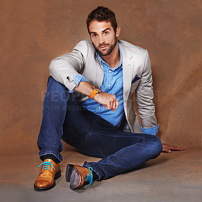 Buy stock photo Fashion, happy and portrait of man in studio with trendy, stylish and classy suit on floor. Smile, model and handsome male person with elegant style for outfit with confidence by brown background.