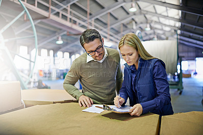 Buy stock photo Factory, writing and manager checking inventory with storage for checklist in supply chain at warehouse. Coworkers, team or employees reading documents or paperwork on clipboard in logistics at depot