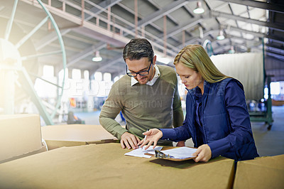 Buy stock photo Business people, reading and checking inventory with storage for checklist in supply chain at warehouse. Coworkers or employees looking at documents, paperwork or clipboard in distribution at factory