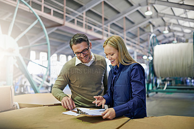 Buy stock photo Happy, business people and reading with checklist for inventory, storage or supply chain at warehouse. Coworkers or employees looking at documents, paperwork or clipboard for distribution at factory