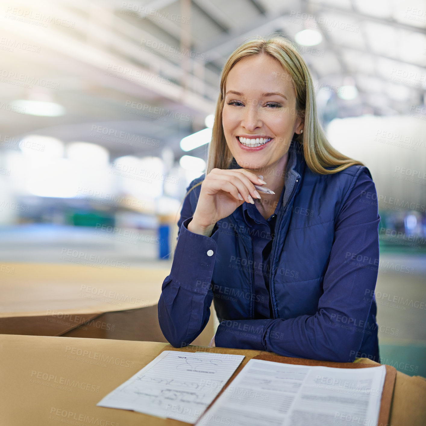 Buy stock photo Portrait, supervisor and smile as businesswoman in logistics at factory with machines for supply chain. Woman, warehouse and table with paperwork for stock take in manufacturing and distribution