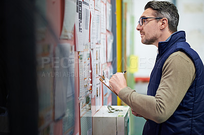Buy stock photo Man, business and board for checking schedule or calendar for shipping details, supplier information and warehouse. Guy, notice or clipboard and thinking for orders or inventory, poster and notes