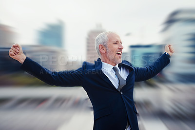 Buy stock photo Enhanced shot of a happy businessman raising his arms while standing in the city