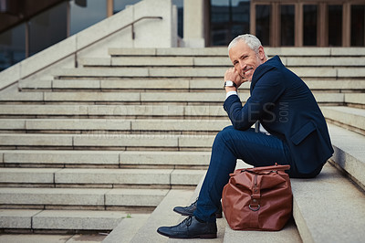Buy stock photo Portrait of a confident businessman sitting on the stairs outside his office building