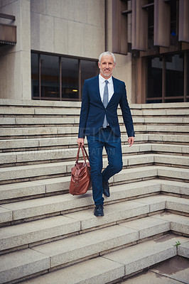 Buy stock photo Portrait of a confident businessman leaving his office building after a day at work
