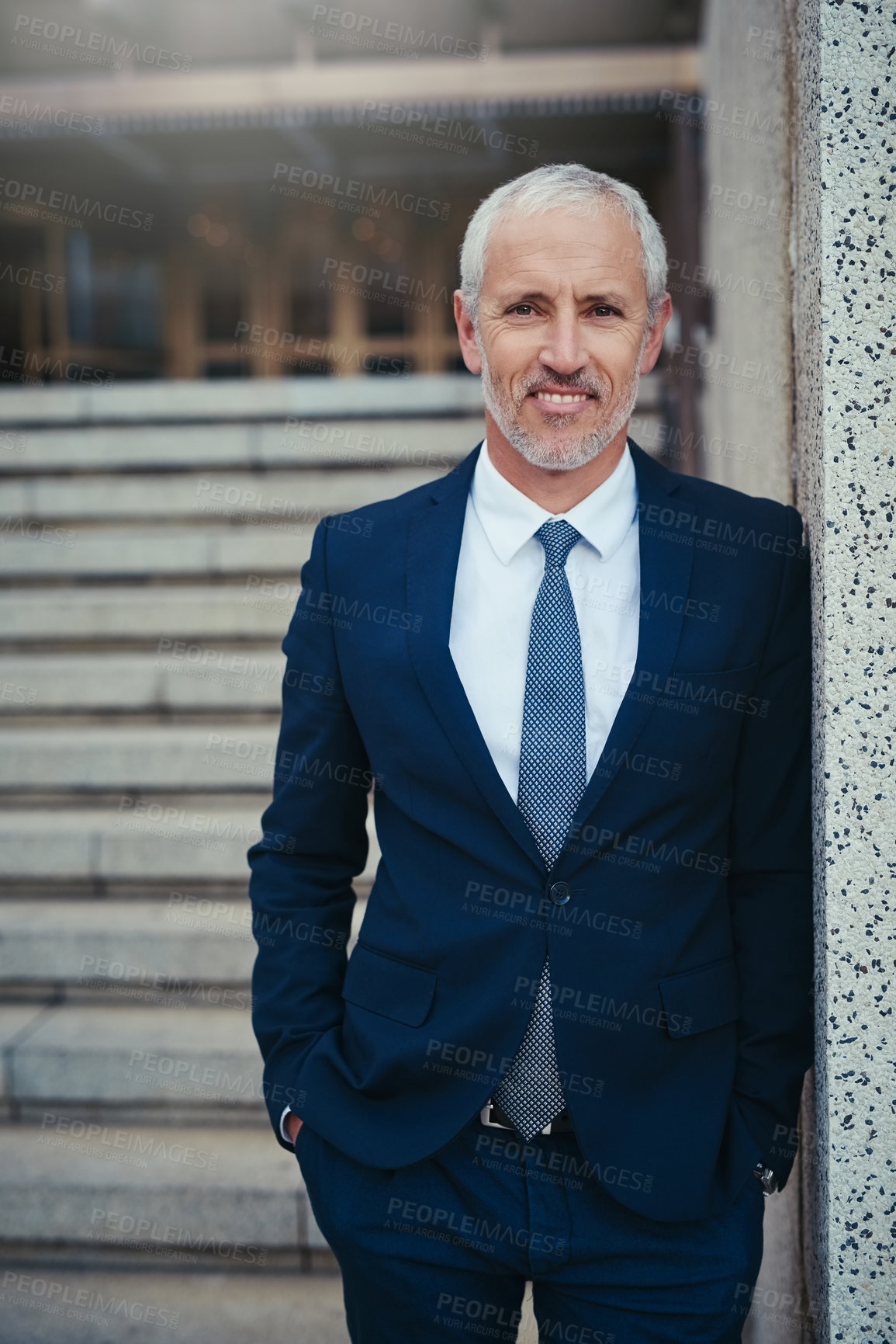 Buy stock photo Portrait of a well dressed businessman standing outside his office building