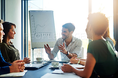 Buy stock photo Shot of a group of colleagues brainstorming together during a presentation