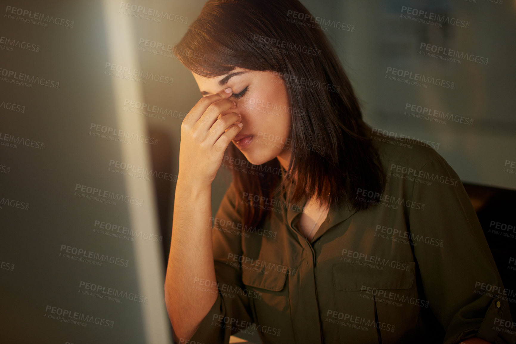 Buy stock photo Shot of a tired businesswoman holding her head while sitting at her computer in the office