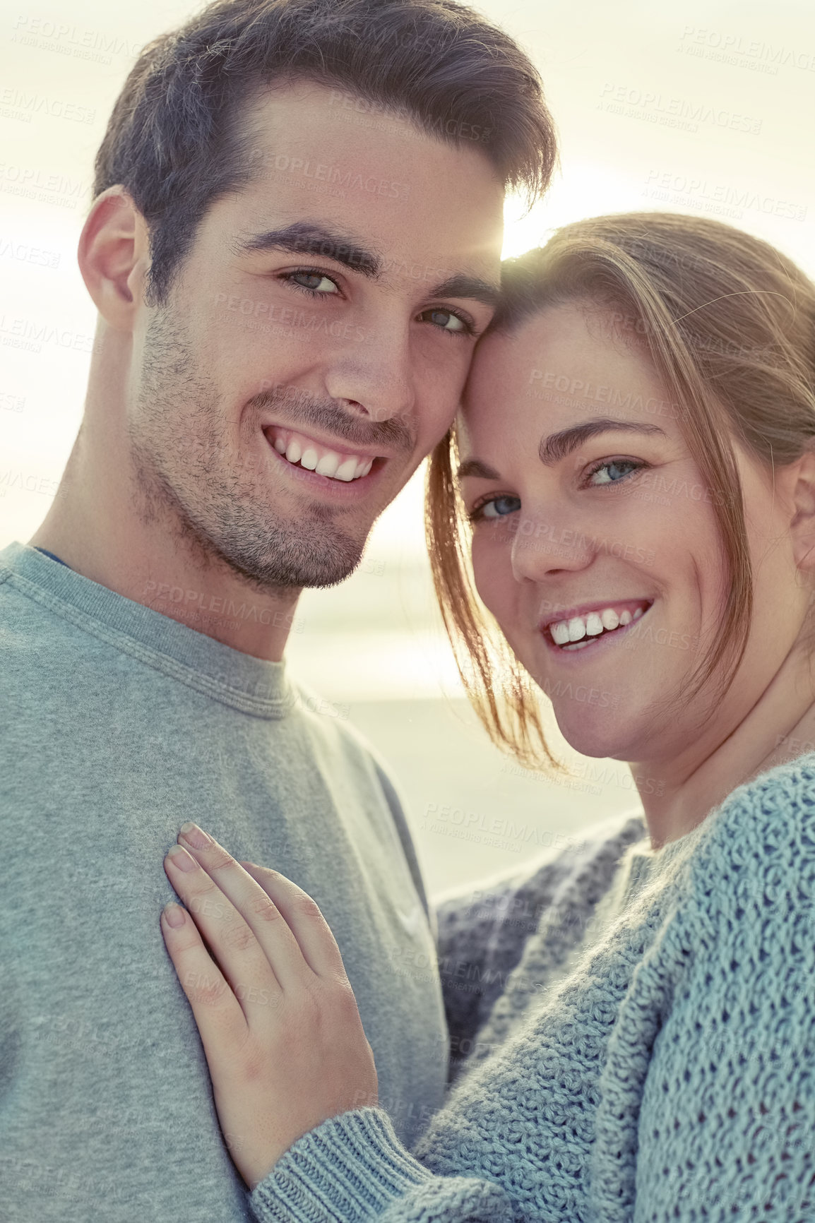 Buy stock photo Portrait, couple and hug with care on beach for romantic getaway on weekend for anniversary and embrace on vacation. Man, woman and bonding together for smile or love, affection and summer holiday