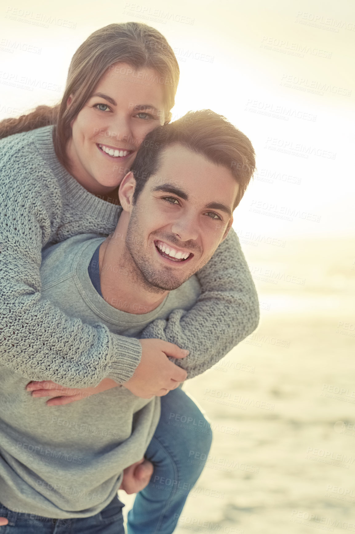 Buy stock photo Piggyback, happy and portrait of couple by beach for romantic vacation, travel or holiday together. Smile, love and young man and woman with fun for bonding by ocean or sea on tropical weekend trip.