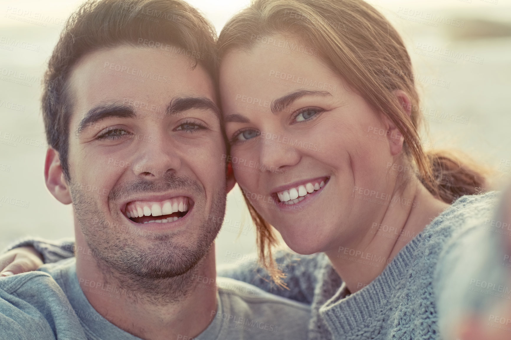 Buy stock photo Portrait, couple and hug with love on beach for romantic getaway on weekend for anniversary and embrace on vacation. Man, woman and bonding together for intimacy or care, affection and summer holiday