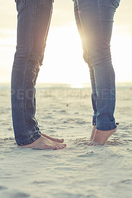 Buy stock photo Shot of an unidentifiable couple enjoying a romantic moment on the beach