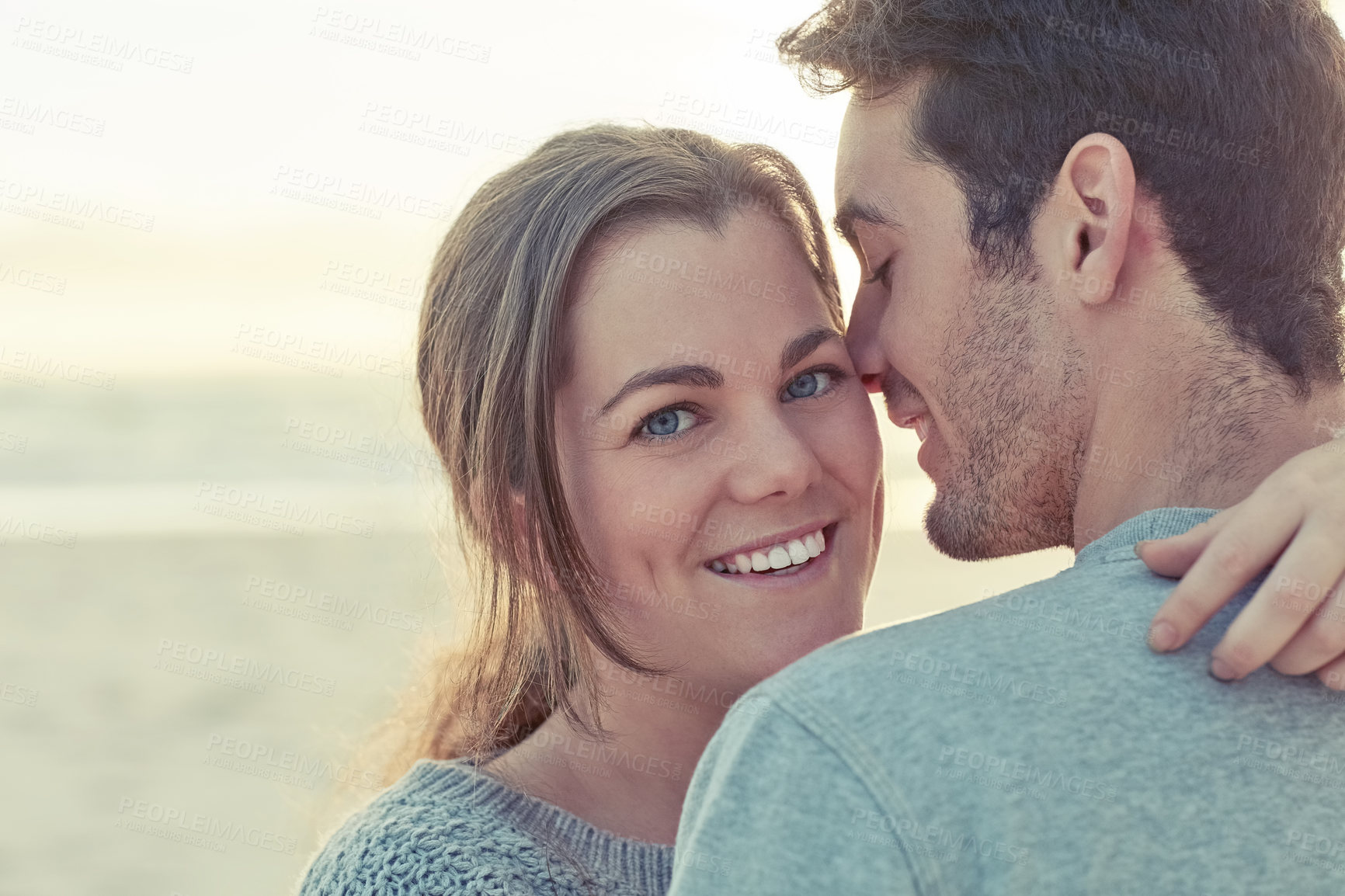 Buy stock photo Hug, smile and portrait of couple by beach for romantic vacation, travel or holiday together. Happy, love and young man and woman embracing for bonding by ocean or sea on tropical weekend trip.