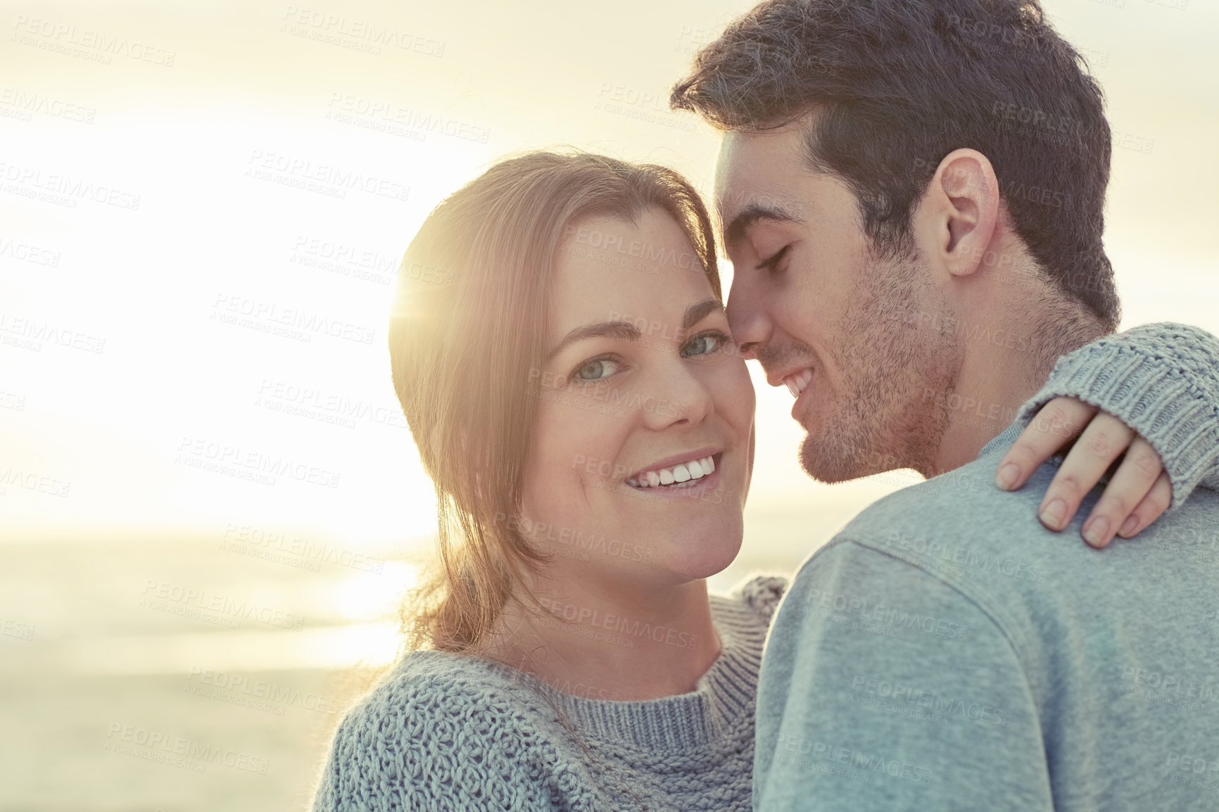 Buy stock photo Hug, love and portrait of couple by beach for romantic vacation, travel or holiday together. Happy, smile and young man and woman embracing for bonding by ocean or sea on tropical sunset trip.