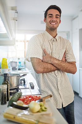 Buy stock photo Portrait of a happy young man posing in his kitchen at home