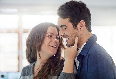 Buy stock photo Shot of a young couple having fun in the kitchen while relaxing at home