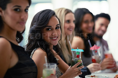 Buy stock photo Portrait of a group of girlfriends enjoying cocktails together on a night out