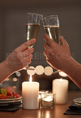 Buy stock photo Cropped shot of a couple toasting during a romantic dinner