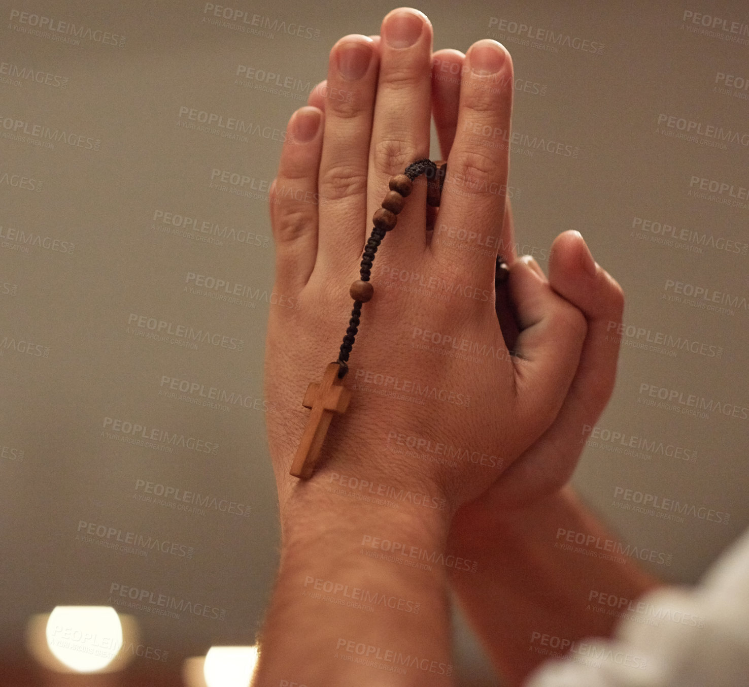 Buy stock photo Cropped shot of a man holding a rosary and praying