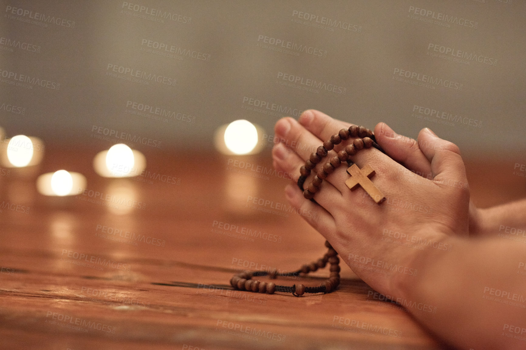 Buy stock photo Cropped shot of a man holding a rosary and praying