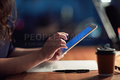 Buy stock photo Cropped shot of a businesswoman using a digital tablet at night in an office