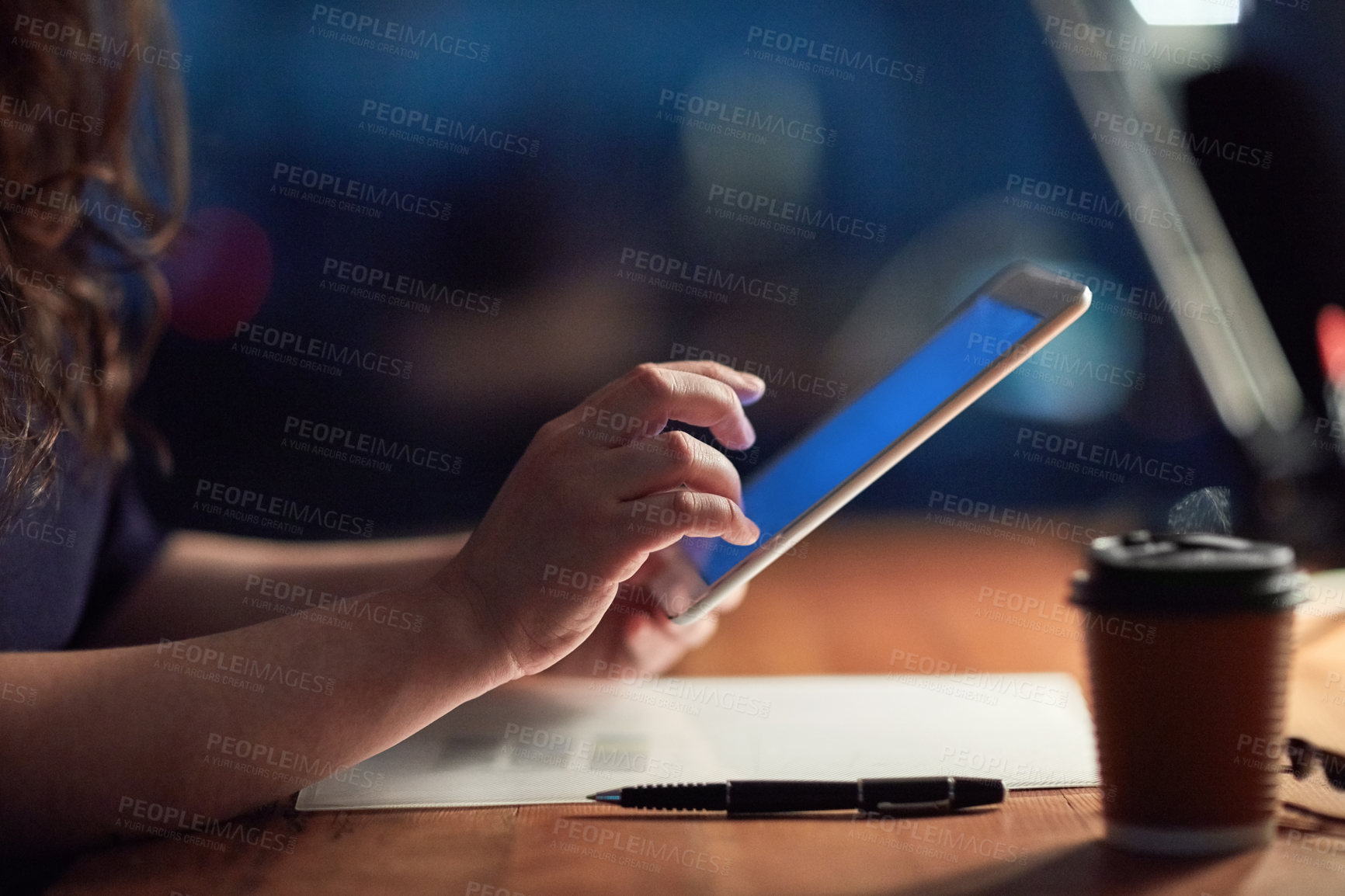 Buy stock photo Cropped shot of a businesswoman using a digital tablet at night in an office