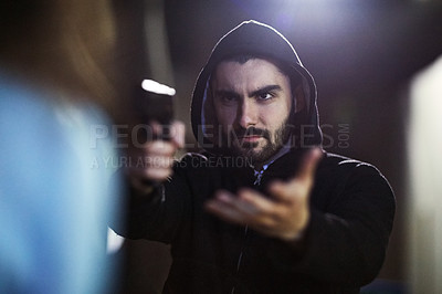 Buy stock photo Shot of a gun-wielding thief threatening an unrecognizable victim