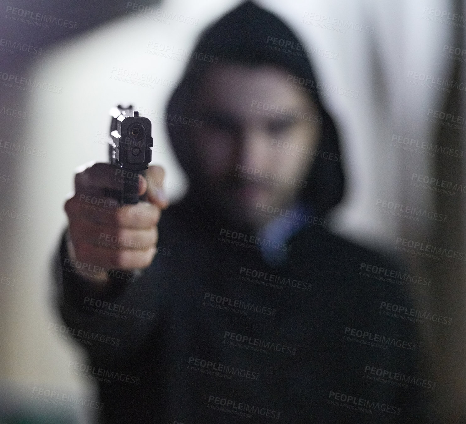 Buy stock photo Shot of a gun-wielding thief aiming his weapon