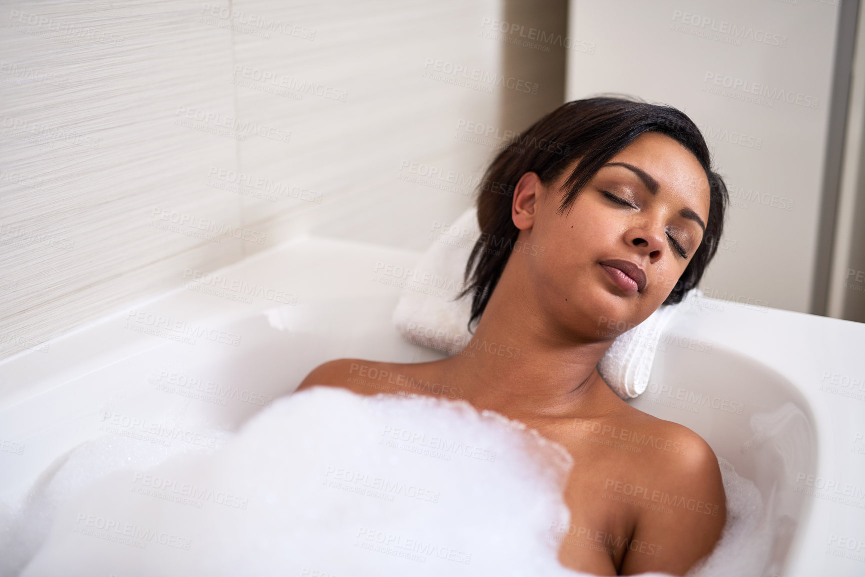 Buy stock photo Bubble, bathtub and woman relax in bathroom for peace, calm and sleeping for beauty at home in the morning. Foam, girl and cleaning in water for skincare, wellness and hygiene health with eyes closed