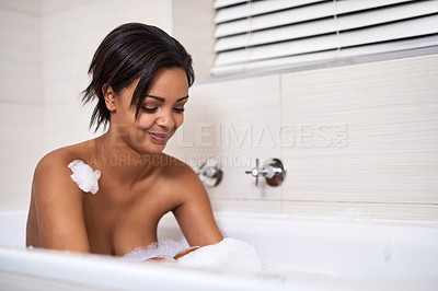Buy stock photo Shot of an attractive young woman relaxing in a bubble bath