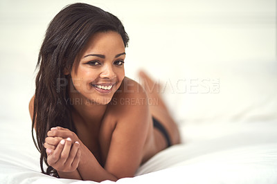 Buy stock photo Portrait of an attractive young woman in her underwear lying on her bed