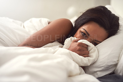 Buy stock photo Portrait of a beautiful young woman lying in bed covering her face with sheets