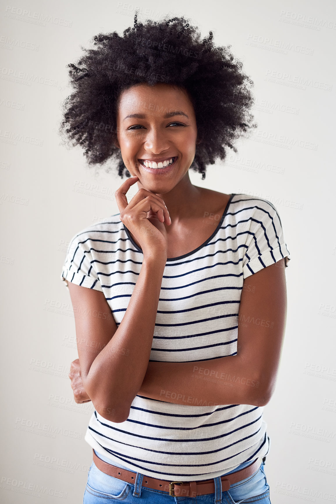 Buy stock photo Studio portrait of an attractive and happy young woman posing against a gray background