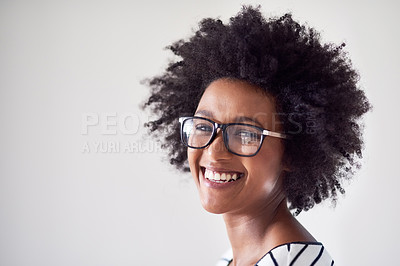 Buy stock photo Studio portrait of an attractive and happy young woman wearing glasses against a gray background