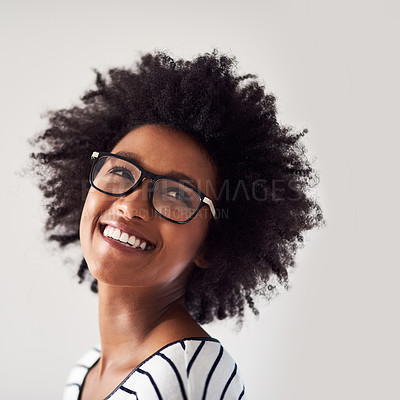 Buy stock photo Studio shot of an attractive and happy young woman wearing glasses against a gray background