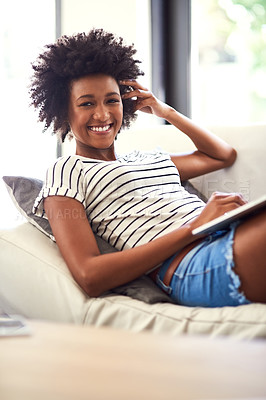 Buy stock photo Portrait of a happy young woman relaxing on the sofa with a laptop