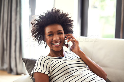 Buy stock photo Portrait of a happy young woman relaxing on the sofa and using her phone