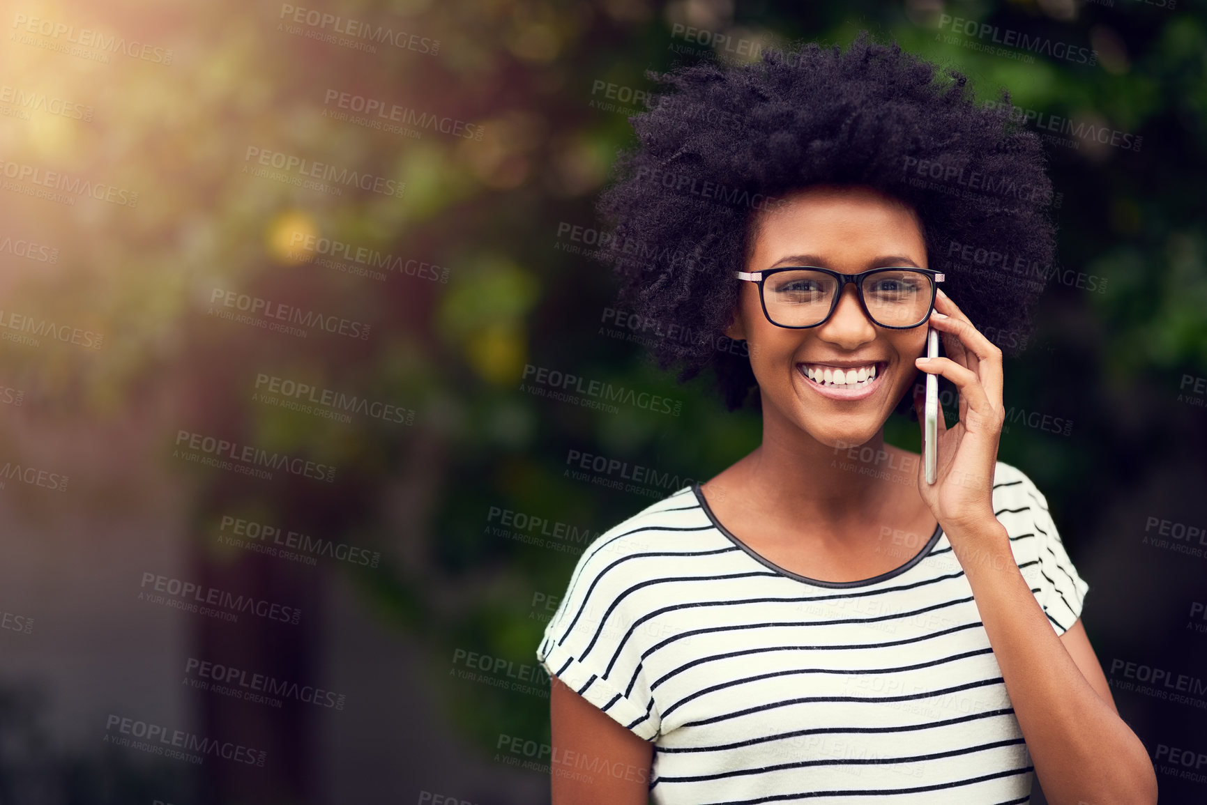 Buy stock photo Portrait of a happy young woman using her phone outdoors