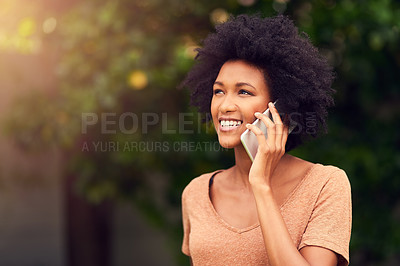 Buy stock photo Shot of a young woman talking on her cellphone while spending the day outdoors