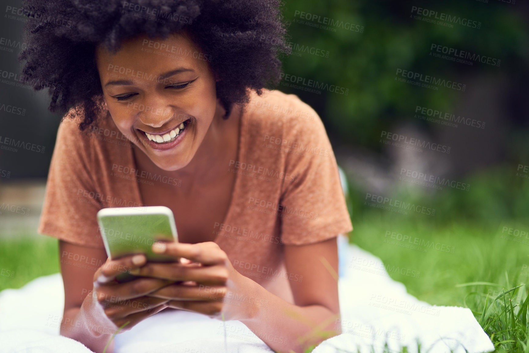 Buy stock photo Meme, mobile or happy woman in park to relax on social media to chat on internet post or notification. Phone search, smile or gen z girl texting online on blog for gossip news on blanket in nature