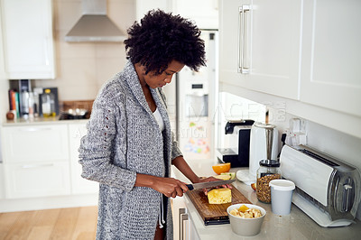 Buy stock photo Shot of a young woman preparing a healthy breakfast in her kitchen at home